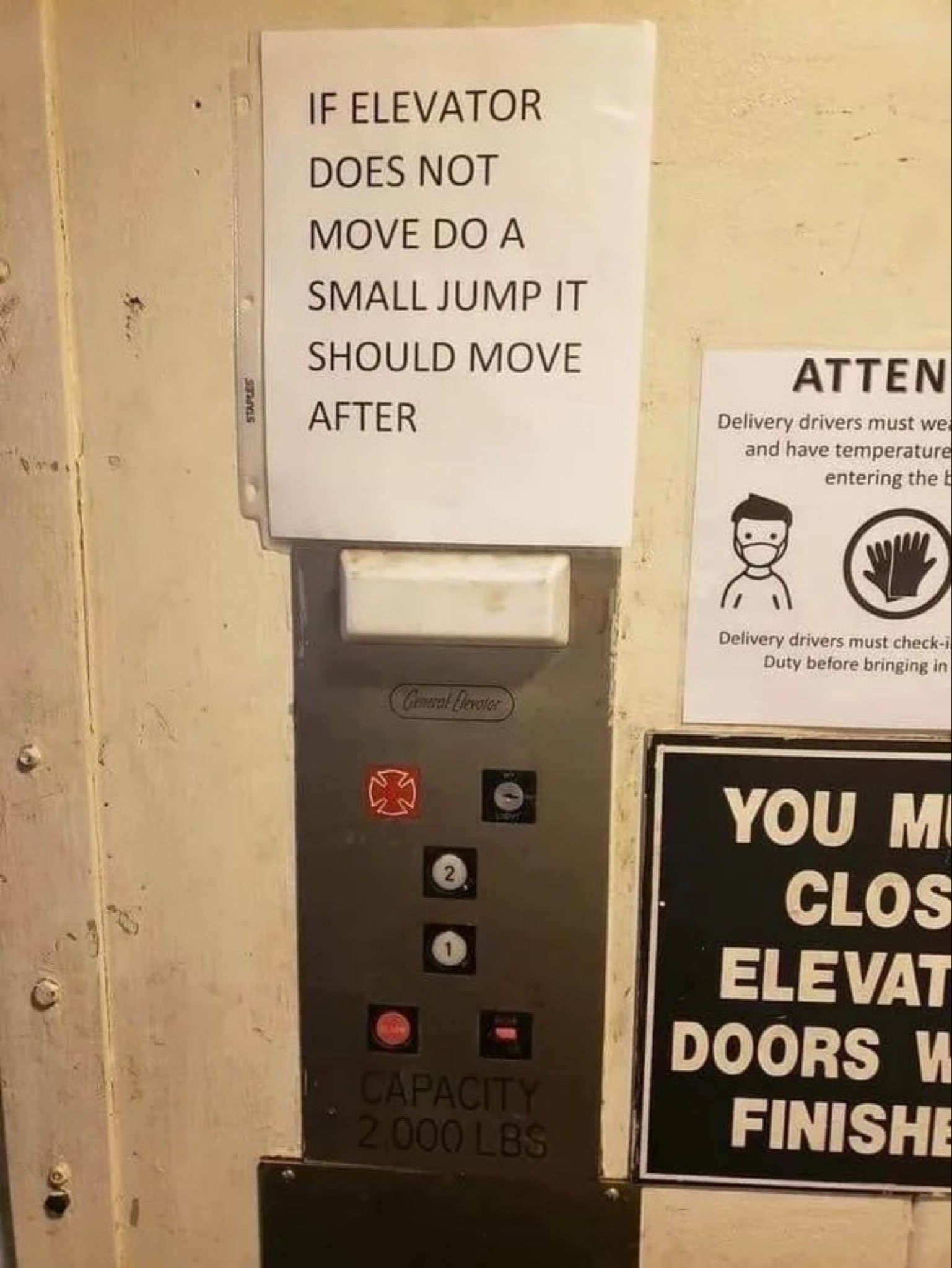 Photo of a paper sign on elevator in a binder sheet that says:

IF ELEVATOR 
DOES NOT 
MOVE DO A 
SMALL JUMP IT 
SHOULD MOVE 
AFTER