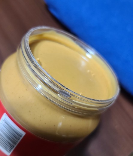Photo of a peanut butter jar with the seal cleanly taken off.