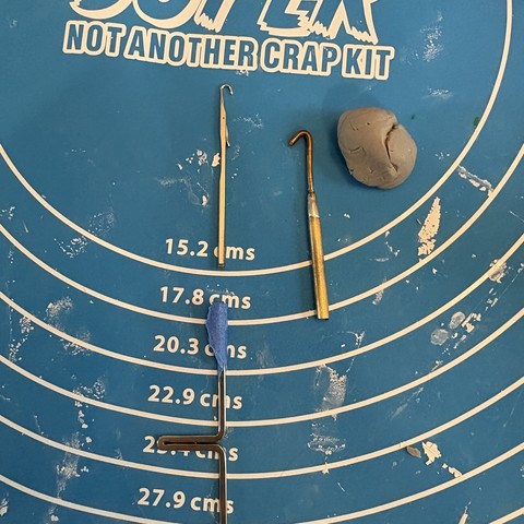 snapped off top of knitting machine needle next to purl tip