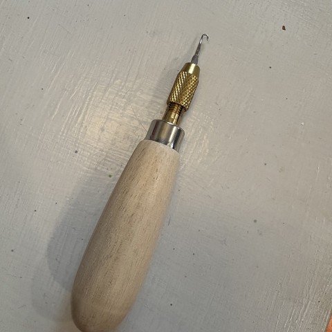 knitting needle tip in loom pick handle