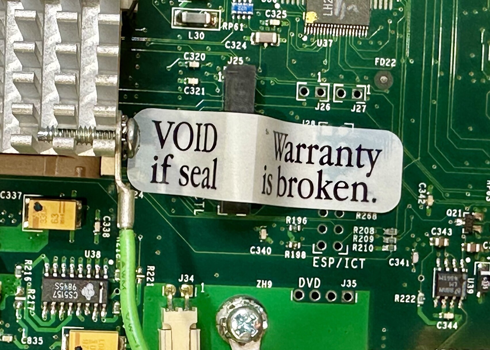 Photo of a circuit board with a sticker on it that says:
VOID Wrranty
if seal is broken.