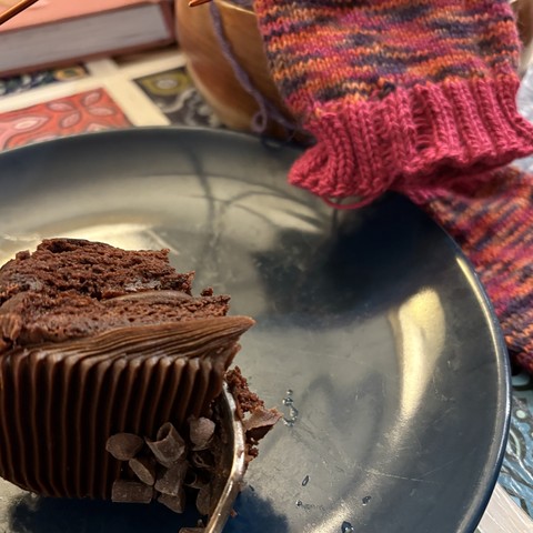A bite of brownie with a badly knitted sock in the background