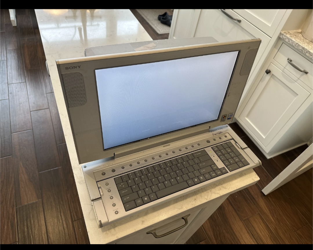 It's pretty much the same as the "Dell Longitude", except it's an actual uhh "desktop computer" sony made with big screen and folding keyboard that leaves half the screen exposed when folded up.  It's very metallic grey and matte grey