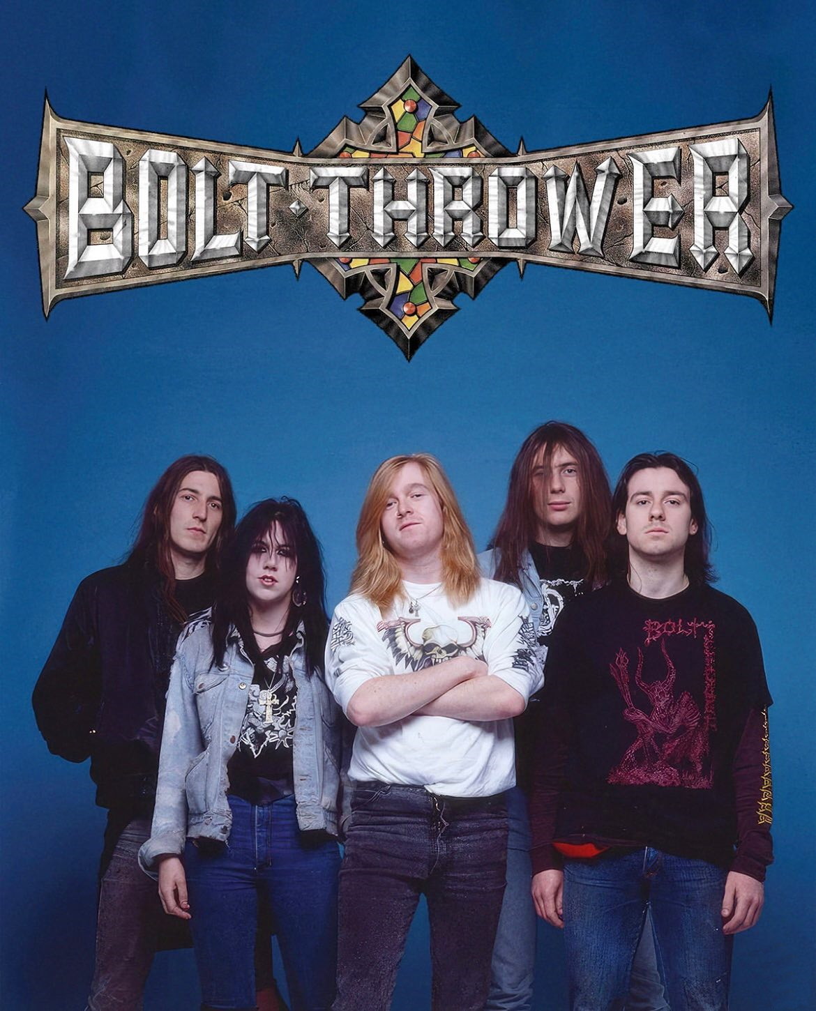 An early 90s promo band photo taken against a blue background. The then-new Games Workshop-licensed Bolt Thrower logo, drawn by Mark Craven and featuring the ominous eight-pointed Chaos symbol at its centre, has been added on top.  
The five members looking straight at the camera are: Barry 'Baz' Thomson (guitar), Jo-Anne Bench (bass), Karl Willets (vocals), Andrew Whale (drums) and Gavin Ward (guitar).