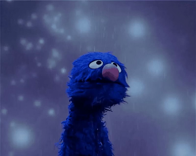 A scene where Grover from Sesame Street is standing in the rain