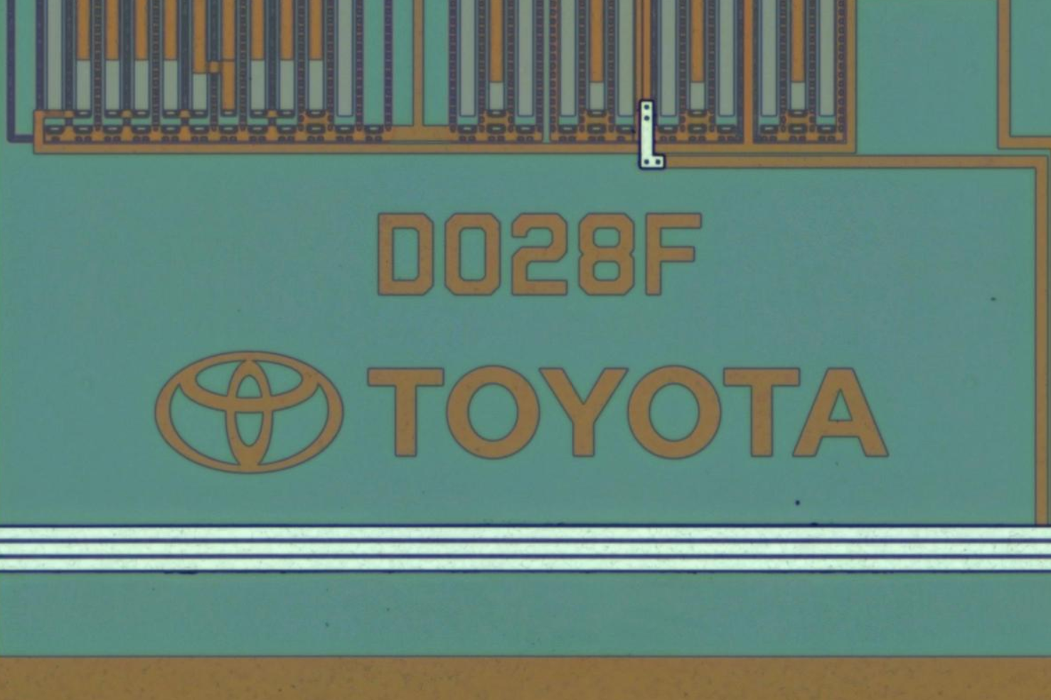 A close-up on the die ID; says D028F on line 1 and has the logo and TOYOTA placed below it.