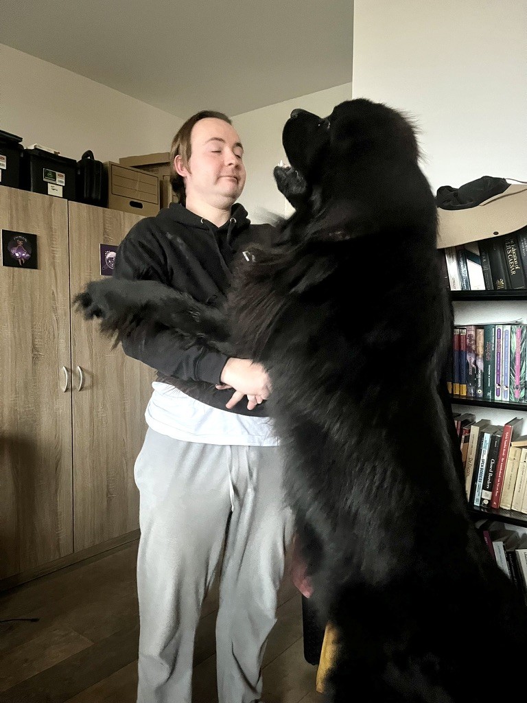 Odin jumping on daddy to stand like a six foot tall human