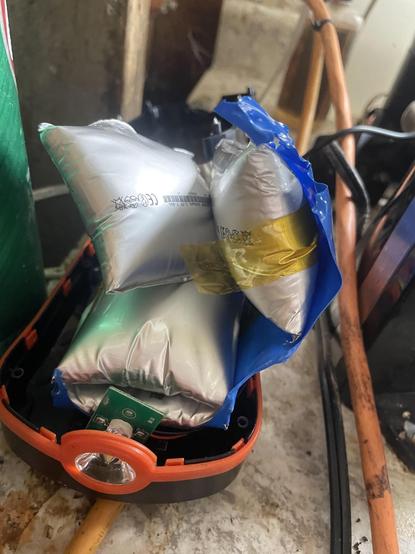 Photo of some kind of portable work light with ballooning lithium battery packs jutting out. The spiciness levels of these pillows it maxed out.