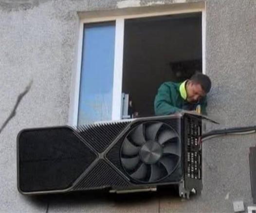 Someone working on an apartment A/C unit that looks suspiciously like a very large GPU