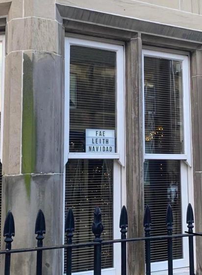 Photo of a window with a sign that says 
FAE
LEITH
NAVIDAD