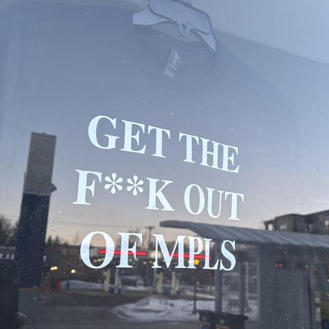 Screenprinted shirt in a shop window: "Get THE F**K OUT OF MPLS"
