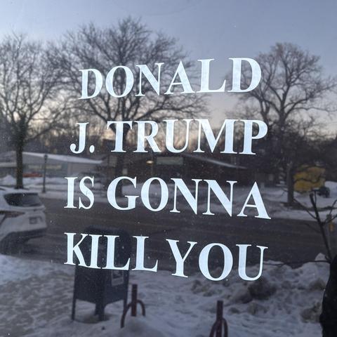 Screenprinted shirt in a shop window: "Donald J. Trump is gonna kill you"