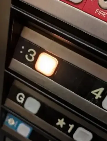 Photo of elevators buttons with the third floor button lit up, except there is a colon in front of the 3

:3
