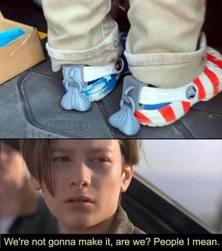The image is a humorous meme combining a picture of Crocs with a scene from the movie "Terminator 2: Judgment Day".

The top half of the image shows a close-up of a person's feet wearing Crocs. The person is wearing light-colored, possibly khaki, pants. Each foot is in a different style of Croc. The left foot is in a blue and white patterned Croc that appears to have a star design. The right foot is in a Croc with red and white stripes, resembling an American flag. Both Crocs have what appear t…