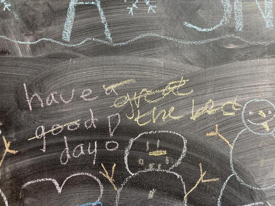 chalkboard writing: "have a good day" with good crossed-out, then great, then great crossed out to say "have the best day"