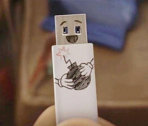 Photo of a USB thumb drive with a smiley face and hands holding a lit bomb drawn on it.
