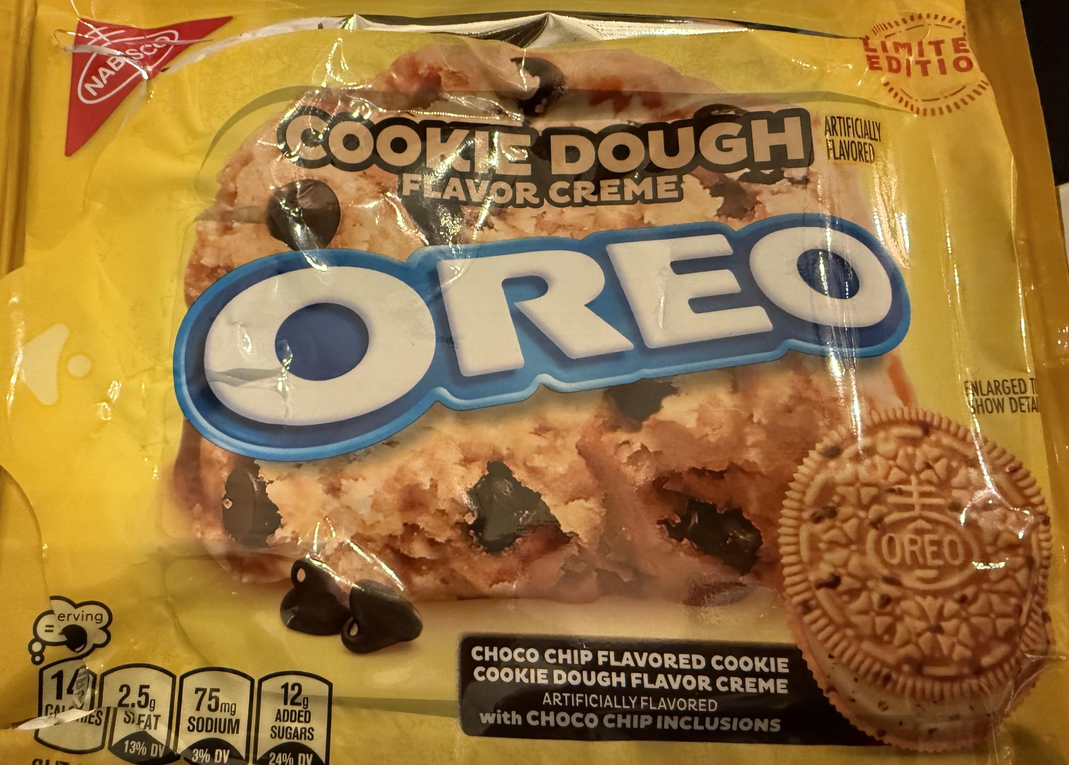 A package of “Cookie dough flavor crème Oreo” cookies. It’s all yellow with tan cookies and extra sized chocolate chips