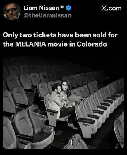 The image is a black and white screenshot from a social media post. At the top left, there is a profile picture of a man wearing sunglasses and smoking. To the right of the profile picture are the words "Liam Nissan™" and a blue checkmark, followed by "@theliamnissan". To the right of this, the X.com logo is visible. Below the profile information, a large white text reads: "Only two tickets have been sold for the MELANIA movie in Colorado". The lower half of the image shows a nearly empty movie…