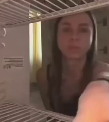 Video of someone placing a cheesecake in a fridge with a camera facing outwards to catch anyone nabbing a slice without permission. They finger point at their eyes and then to the camera to let whoever know this cake is under surveillance. Time jump to later with someone else opening the fridge smiling while aiming for the cheesecake, but the smile goes away as they notice the camera. They close the fridge in defeat, but soon after the fridge opens up again. This time, however, it's a tuxedo ca…