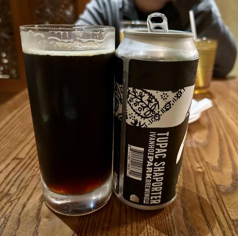 Picture of a glass and the can of a very dark beer - a Porter