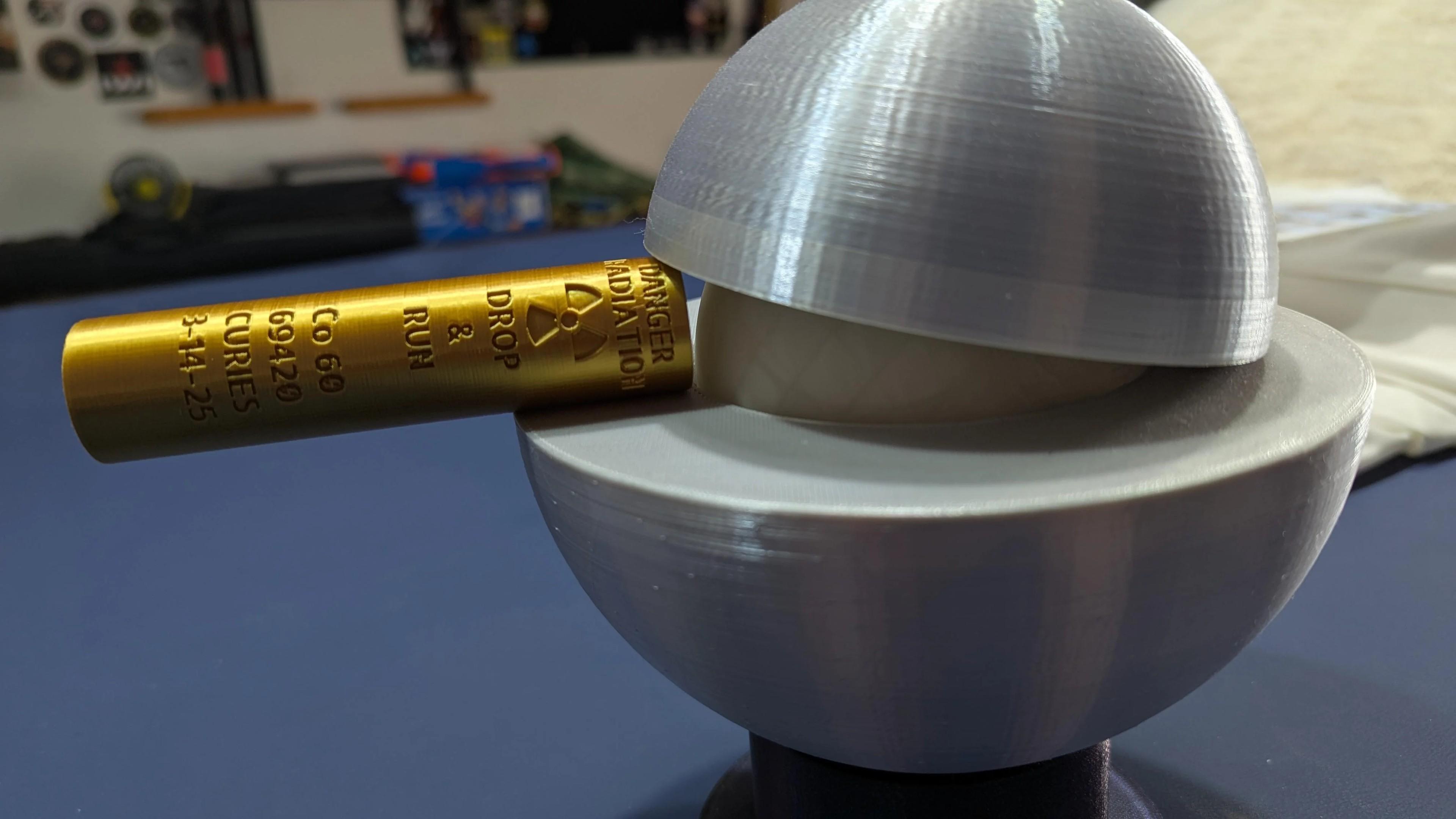 Photo of a 3D printed demon core being propped open with a Co66 Drop & Run stick