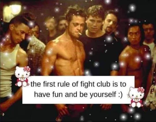 The image appears to be a still from a movie, possibly "Fight Club," given the text overlay. It depicts a group of muscular men standing together in what seems to be an indoor setting, perhaps a dimly lit bar or club. The lighting is atmospheric, with a warm, somewhat hazy glow. Many of the men are shirtless or wearing tank tops, highlighting their physiques.

Overlaying the bottom half of the image is a white rectangular text box containing the words "the first rule of fight club is to have fu…