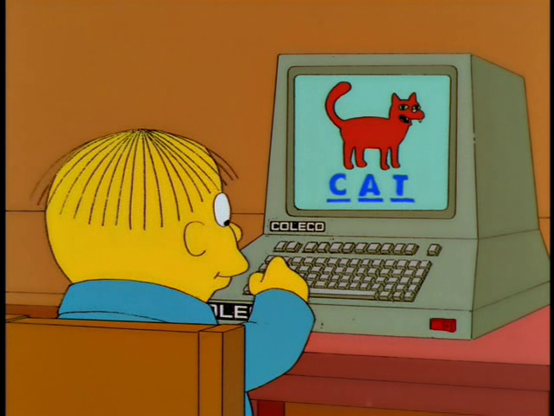 Ralph from the Simpson's typing the word CAT into a Coleco computer showing a picture of a red cat.