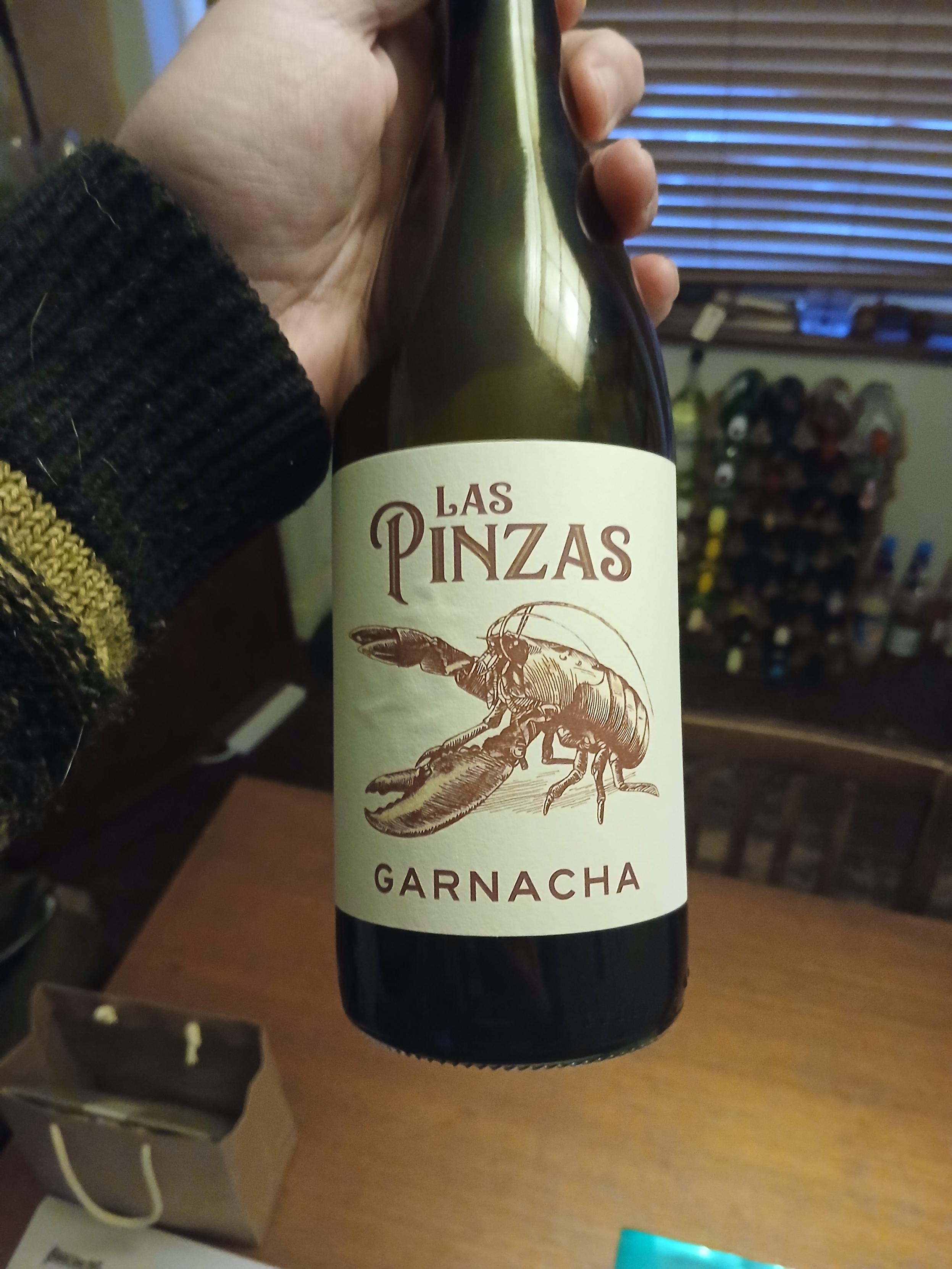 A bottle of red wine. The text reads LAS PINZAS. GARRNACHA. And there's a very pleasing line illustration of a lobster.