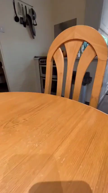 Reversed video of a cat taking a treat off a table. Since it's backwards, the video actually looks like kitty sitting on a chair pops its head up (while giving the cheesy puff a couple of licks), places it on the table using both paws, and then watches the human reach over to grab the tasty cheese ball. 

Human can have a little treat... as a treat!