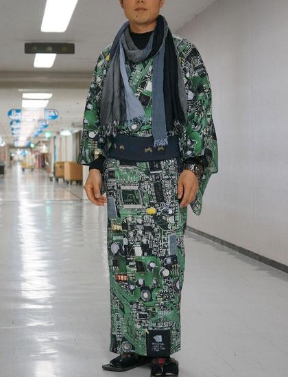 Photo of a monk wearing an outfit with a circuit board print