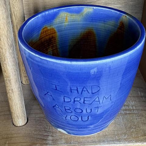 blue pottery cup that reads "I had a dream about you" on the outside