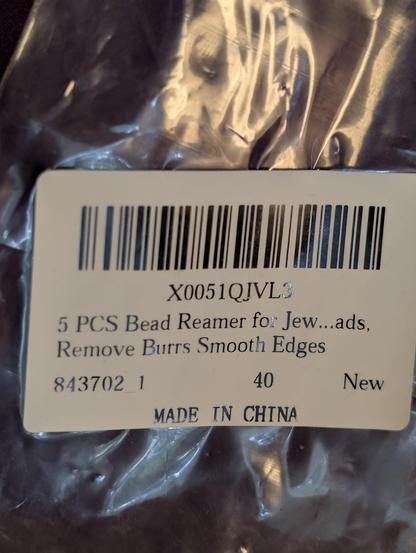Barcode sticker on a clear plastic package that says, "5 PCS Bead Reamer for Jew ... ads. Removes Burrs Smooth Edges".