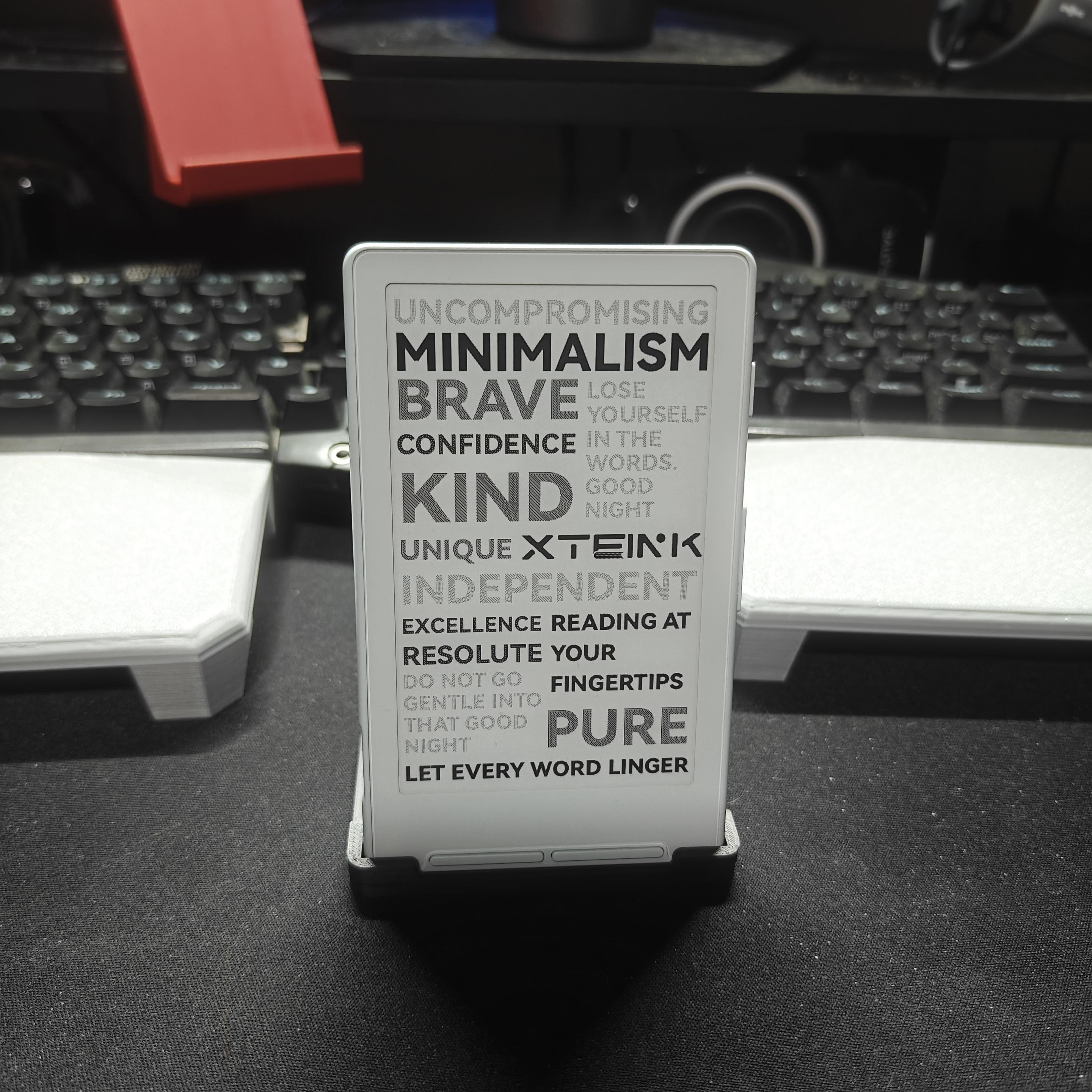 xteink x4 ebook reader sitting vertically in a stand