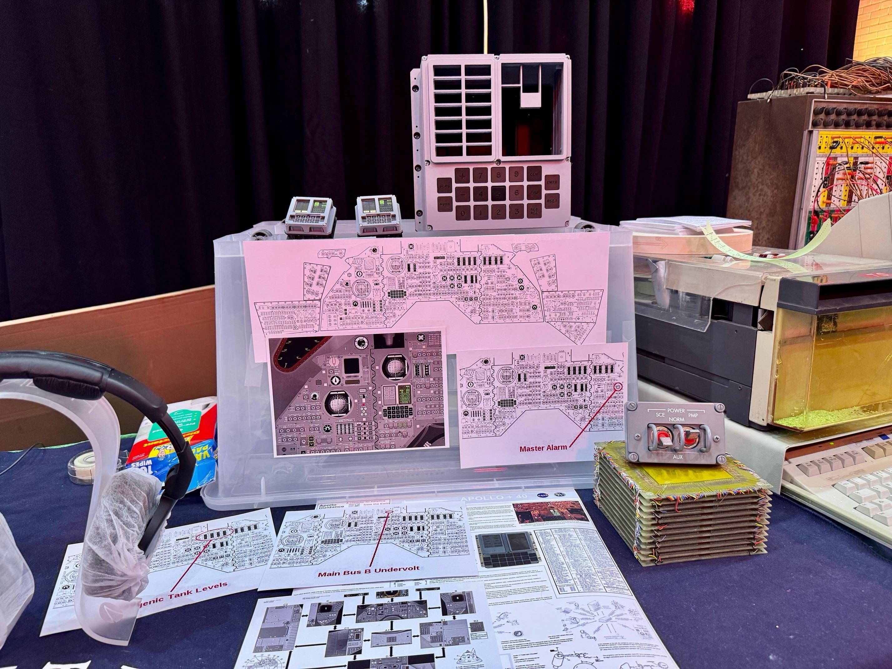 a photo of part of an Apollo Guidance Computer (AGC) display I put together for a local vintage computer exhibition 
 
it shows a 1:1 3D-printed DSKY (DiSplay & KeYboard) & some “baby DSKYs” and informational diagrams about the DSKY sat in the Command Module (there’s a second DSKY in the Lunar Module, not shown), and an “SCE to AUX” switch sitting atop some magnetic core memory