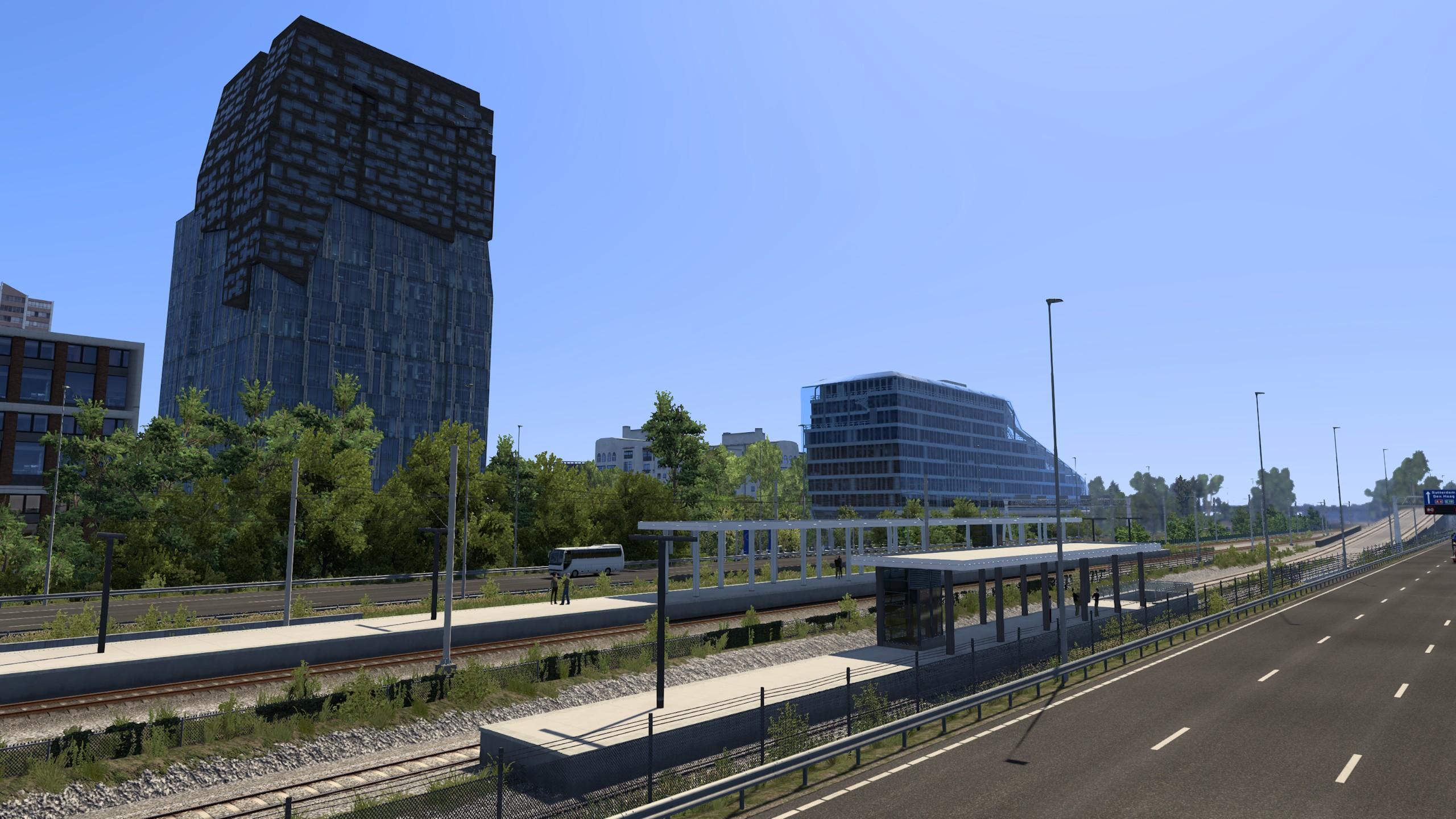 view of a station platform with Amsterdam Zuid behind, including the boat building