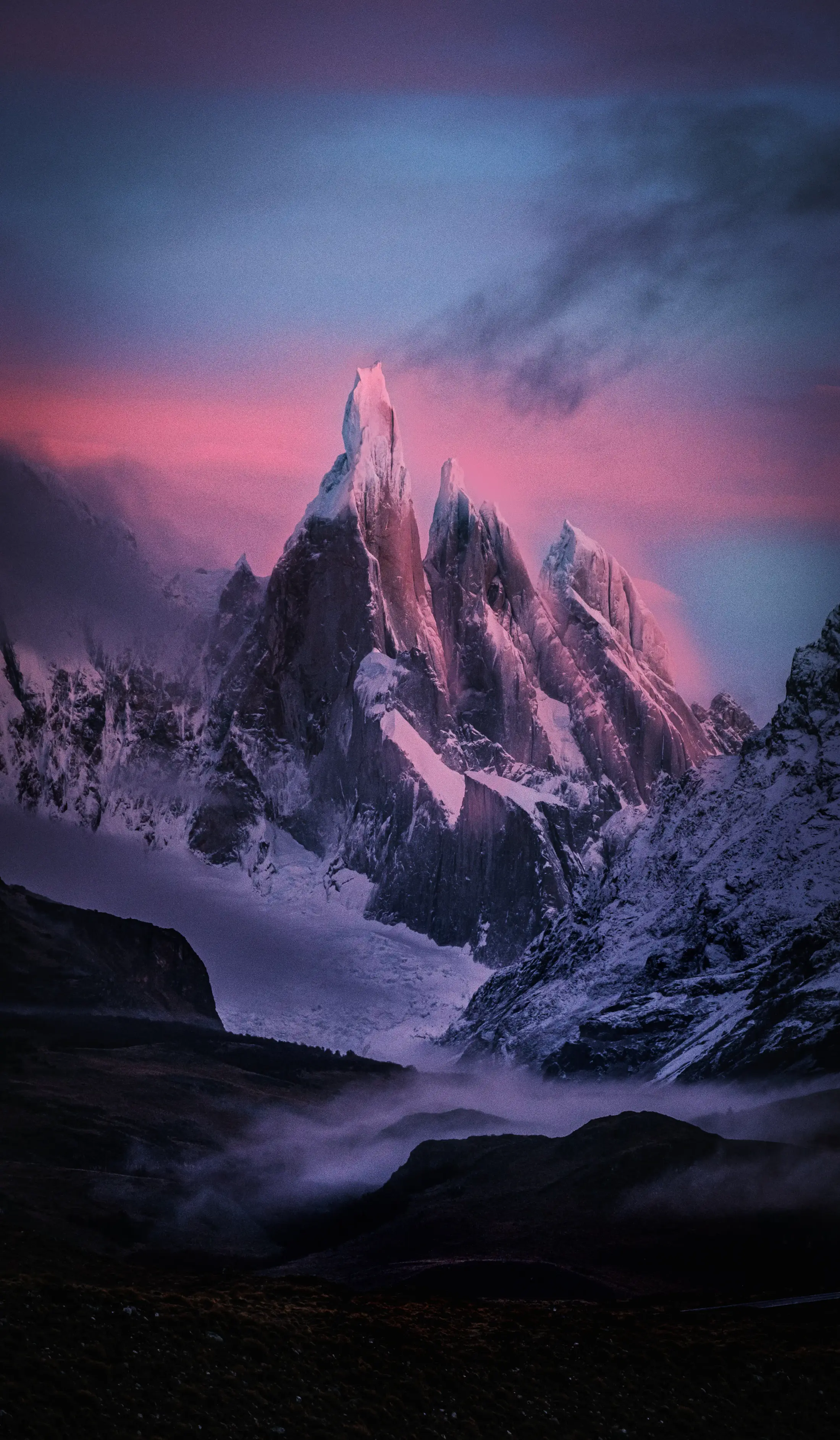 the Cerro Torre Mountain range at sunrise. The colors are the trans flag colors.