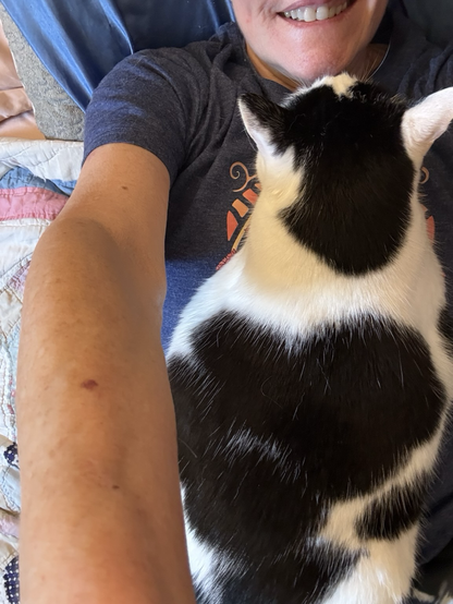 My sweet cat is lying down on top of me and I can’t move 
