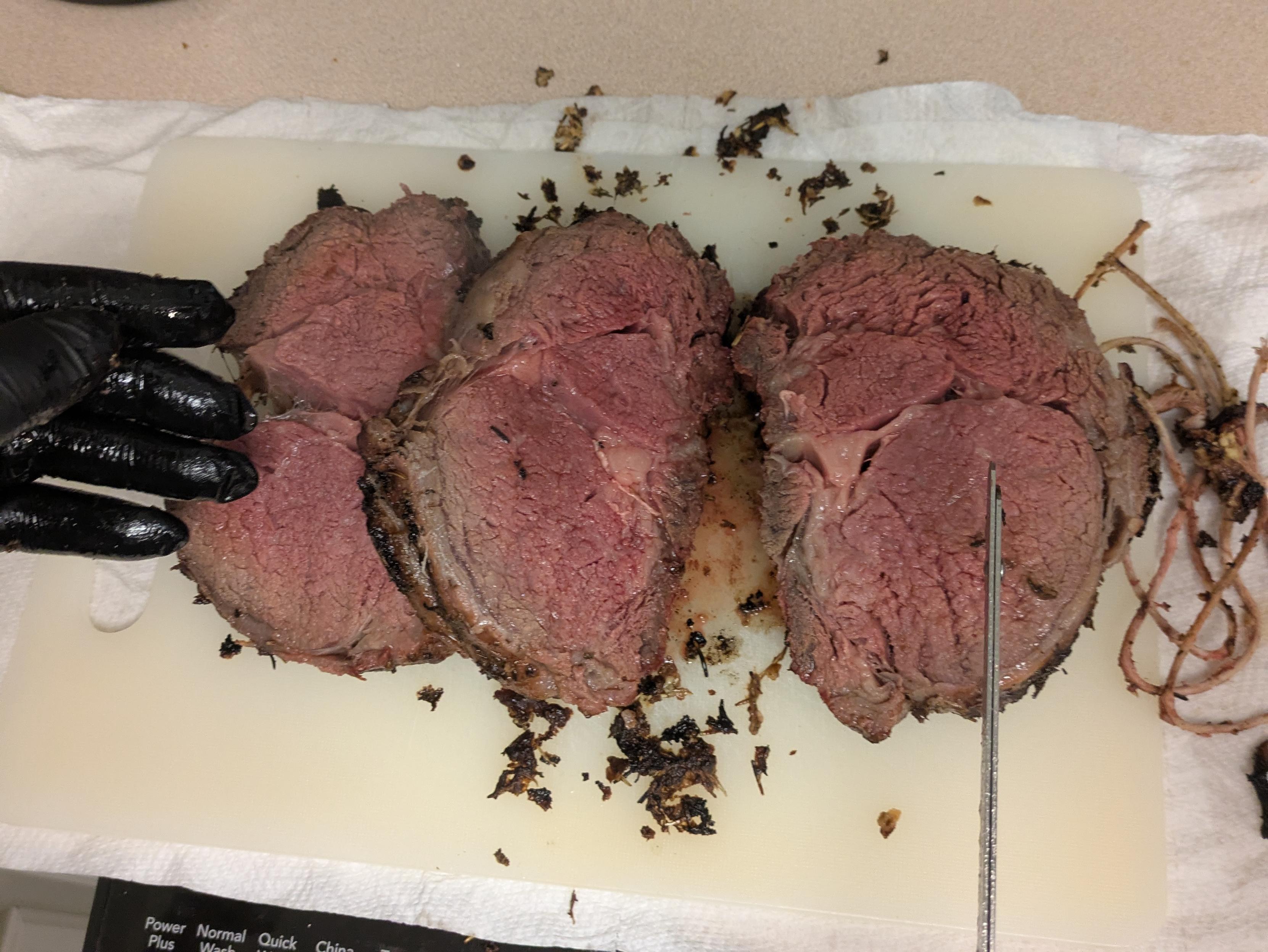 Some slices of a perfect medium rare smoke prime rib roast. Over charcoal and cherry wood.
