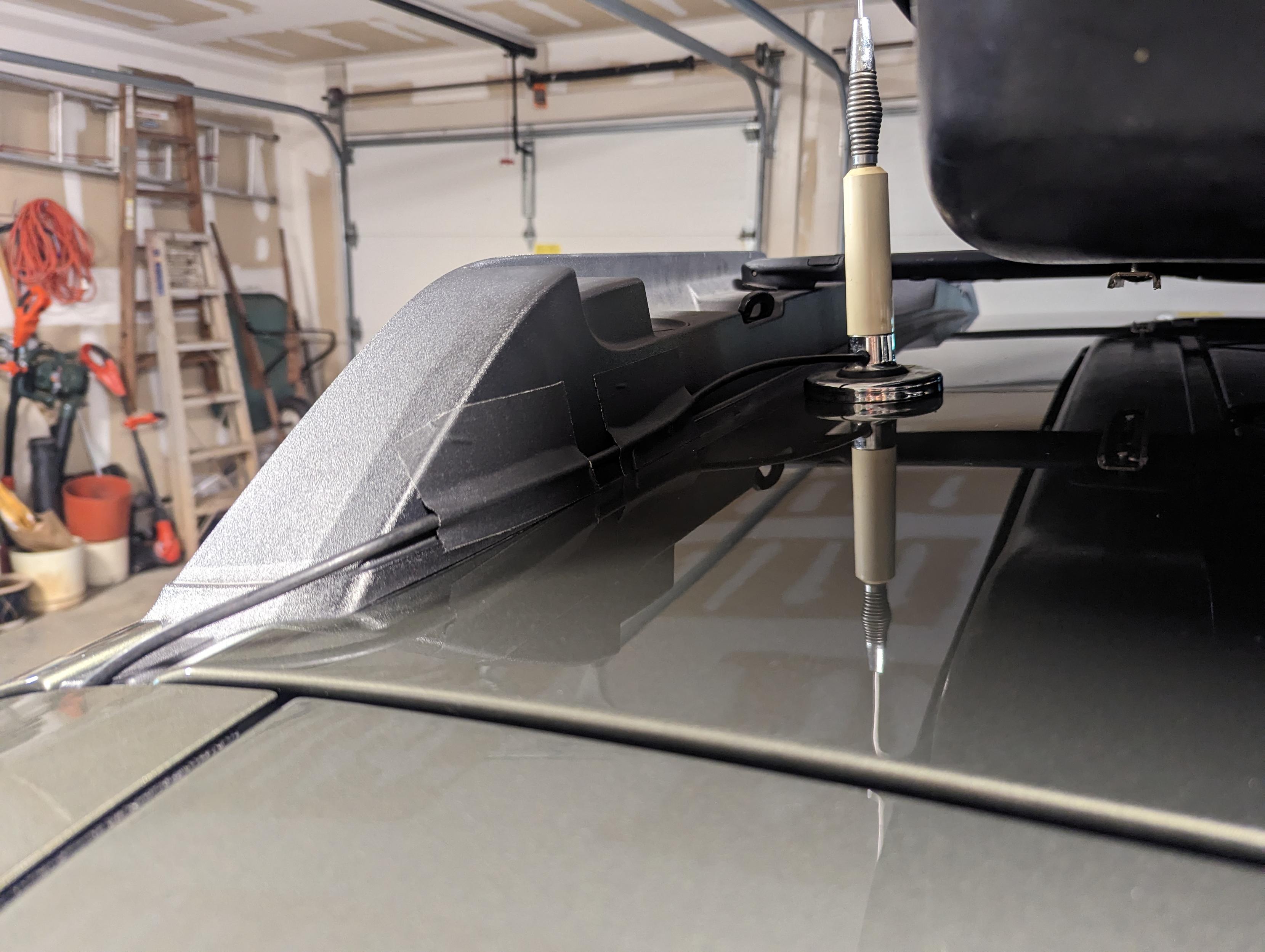 The coax cable coming from the mag mount antenna, taped to the roof rack rail using a couple pieces of black gaffer tape before it goes into the gap for the back hatch.