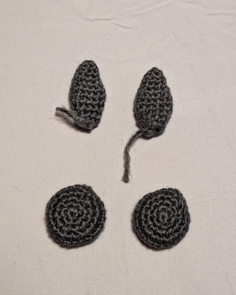 a crosshatch-textured crochet cowl and beanie in Malabrigo Sabiduria (variegated black/purple/magenta), with the yarn balls still attached