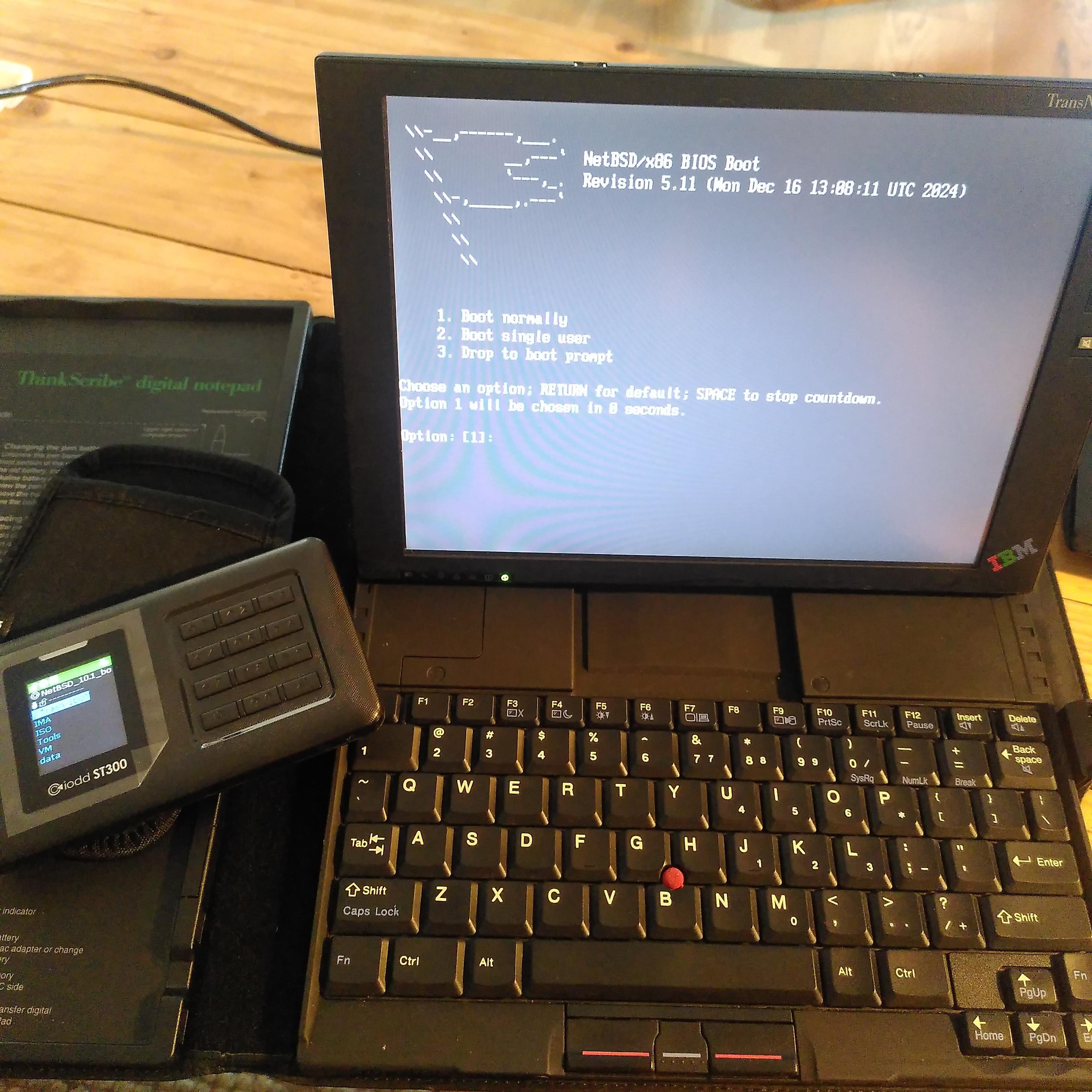 a picture of an IBM Transnote, running the NetBSD 10.1 installer.
it has booted from an ISO stored on a USB3 IODD ST300 optical disk emulator, plugged on a USB 1.1 port