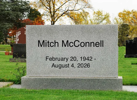The image depicts a gravestone in a cemetery. The gravestone is made of speckled gray granite and has a rectangular shape with a slightly rounded top. It is mounted on a wider, stepped granite base. The text on the gravestone is etched in black and reads "Mitch McConnell" on the top line, followed by "February 20, 1942 -" on the second line, and "August 4, 2026" on the third line. The composition is centered on the gravestone, which occupies a significant portion of the frame.

The background s…