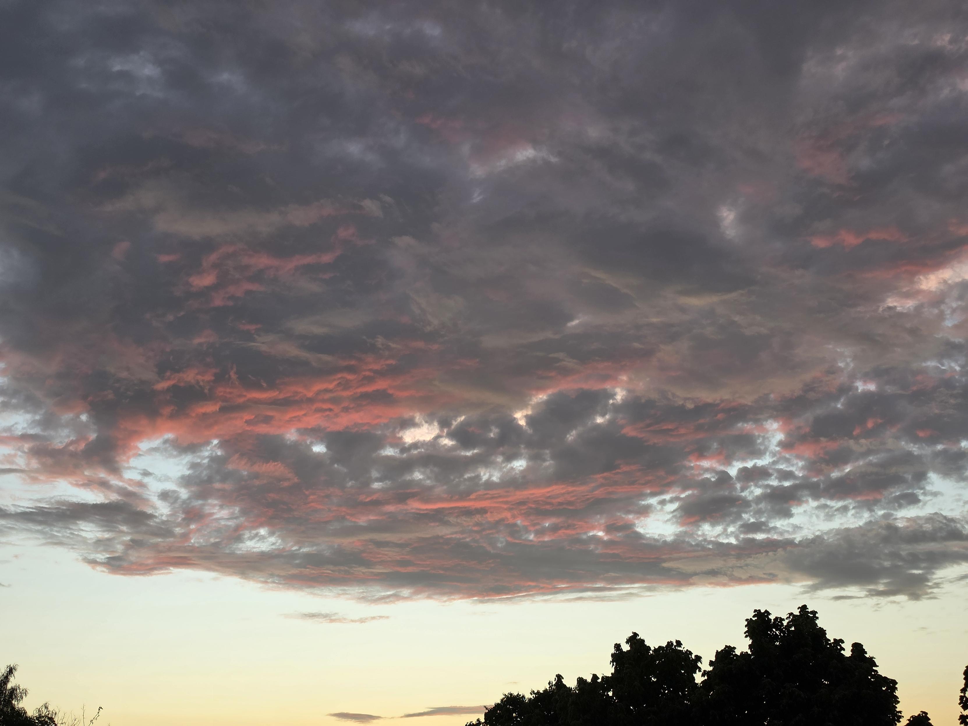 sunset clouds with reddish orange tips from the the sunset