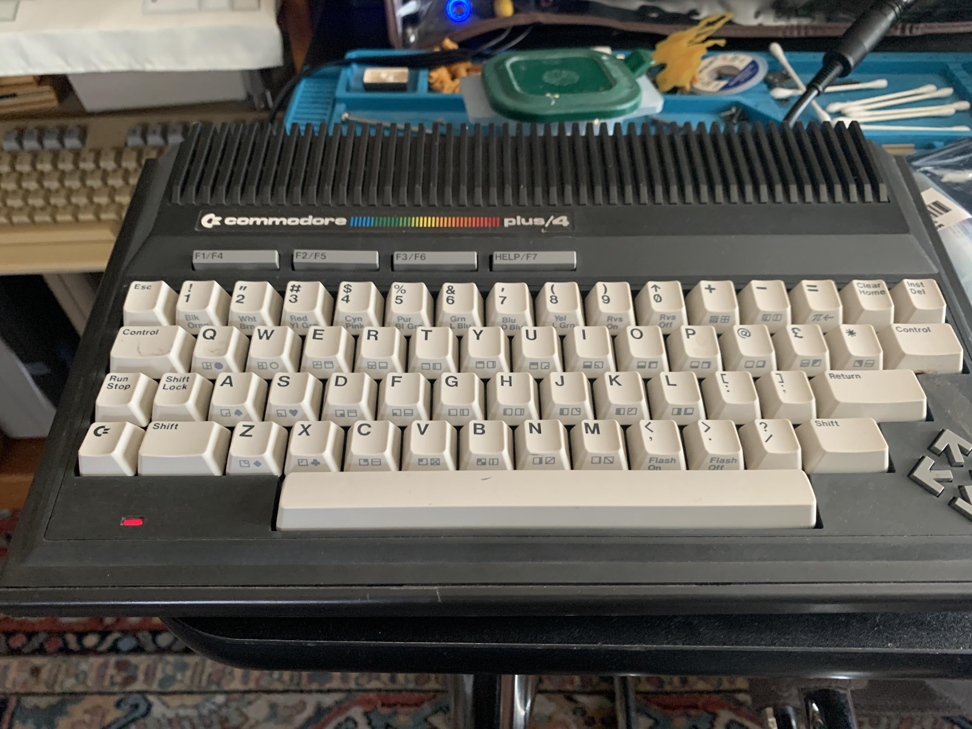 Commodore plus/4 computer.  Black case with grey keyboard.  All in one computer.