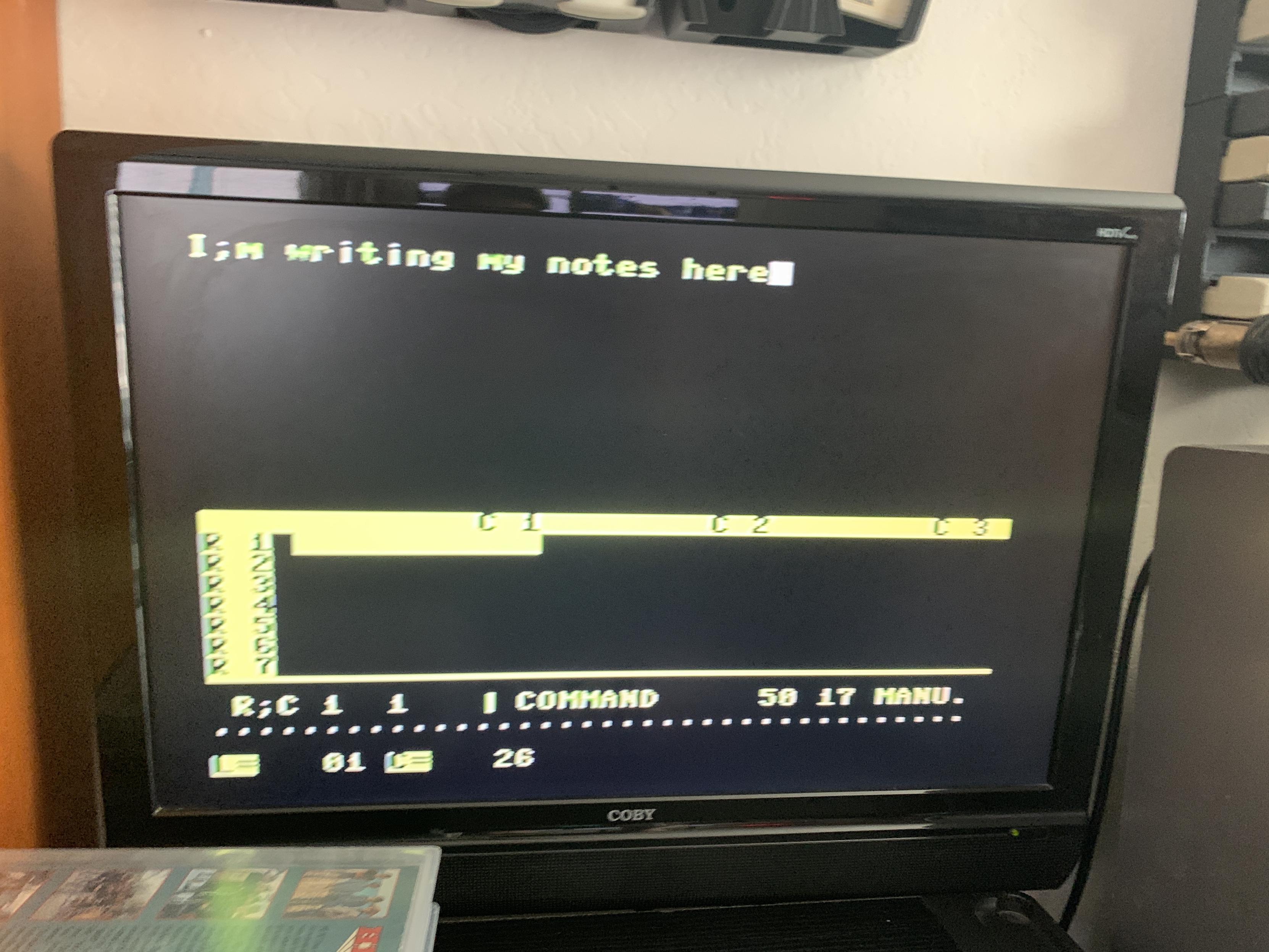 Yellow text on black background rendered on a wall mounted LCD television.  The screen is horizontally divided into two areas.  The top half is occupied by the word processor built in.  The words "I;m writing my notes here" appears in yellow text.  The bottom half is an inscrutable spreadsheet program that would required a few hours of manual reading to understand.  Column and row headers are displayed in inverted text.  The word "Command" is in the bottom center to indicate what mode the input currently is toggled to.