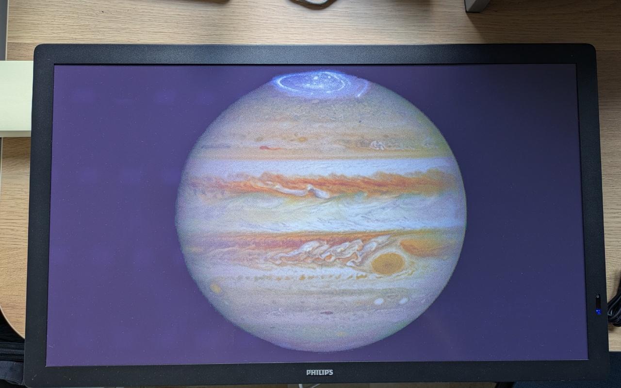 A huge colour e-ink display showing a NASA photo of Jupiter.