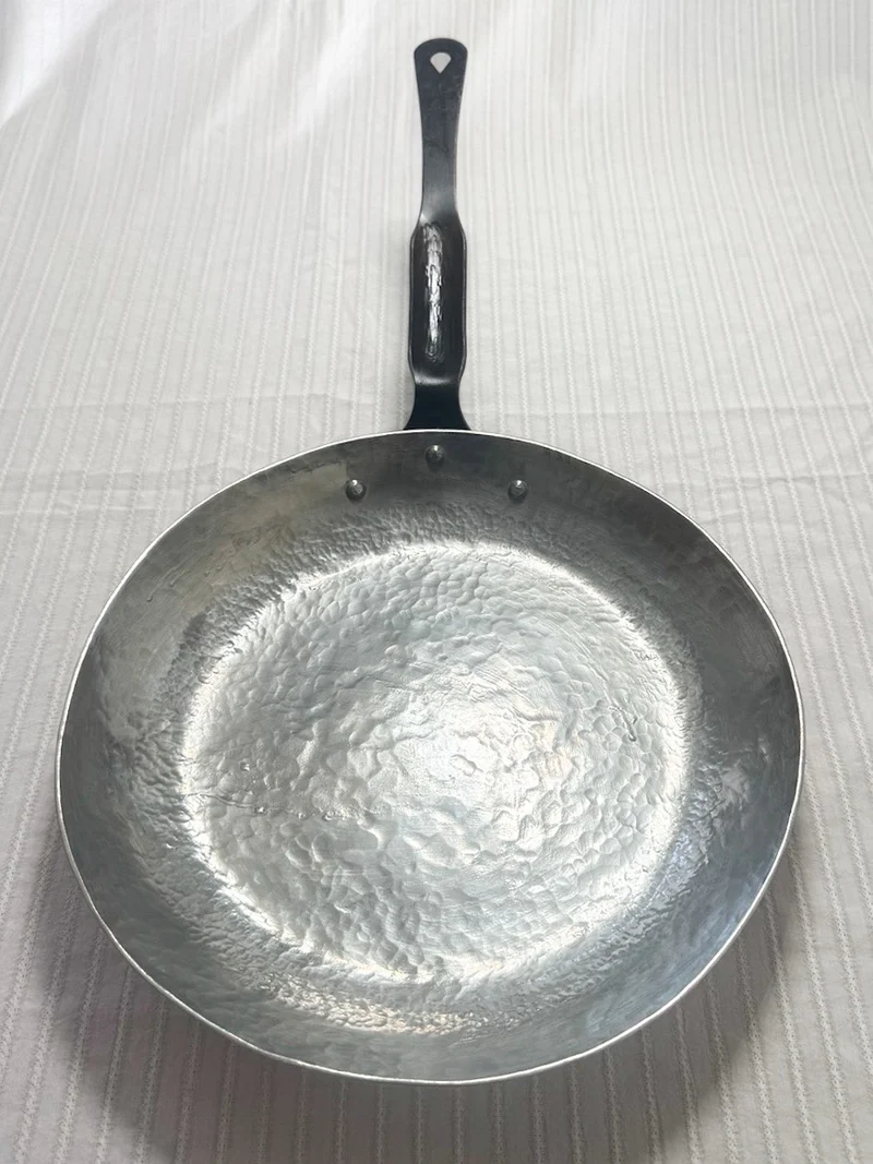 Cooking side of the pure-tinned interior of the hand-raised tinned-copper sauté pan from Rocky Hill Forge. Tinning by Normandy Kitchen Copper