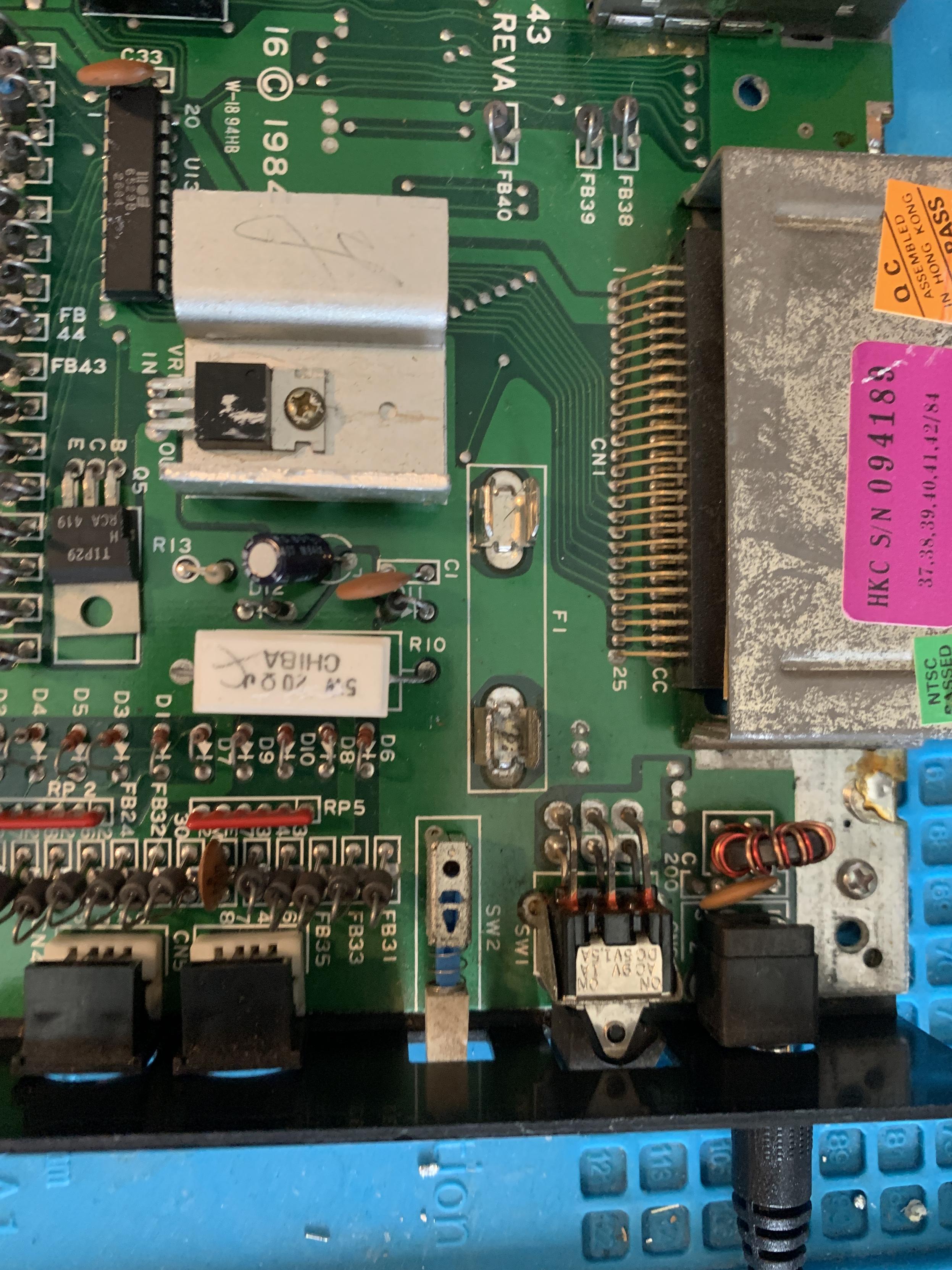 The location of the fuse on a Commodore16 mail board. Green PCB.