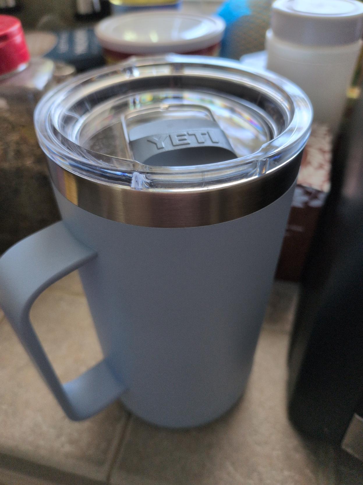 A lavender Yeti cup with magnetic locking lid. Flip it shut, it shouldn't spill much if at all.