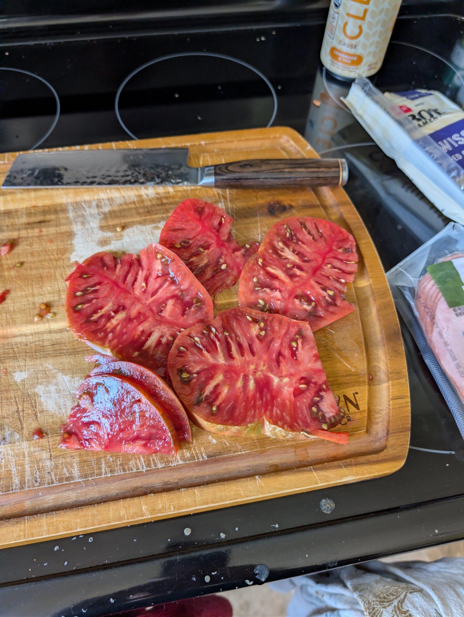 A cut up tomato, probably black krim we lost our label for it. Its a large and meaty tomato with a beautiful dark green/red hue around the edges. Tasted great on a sandwich